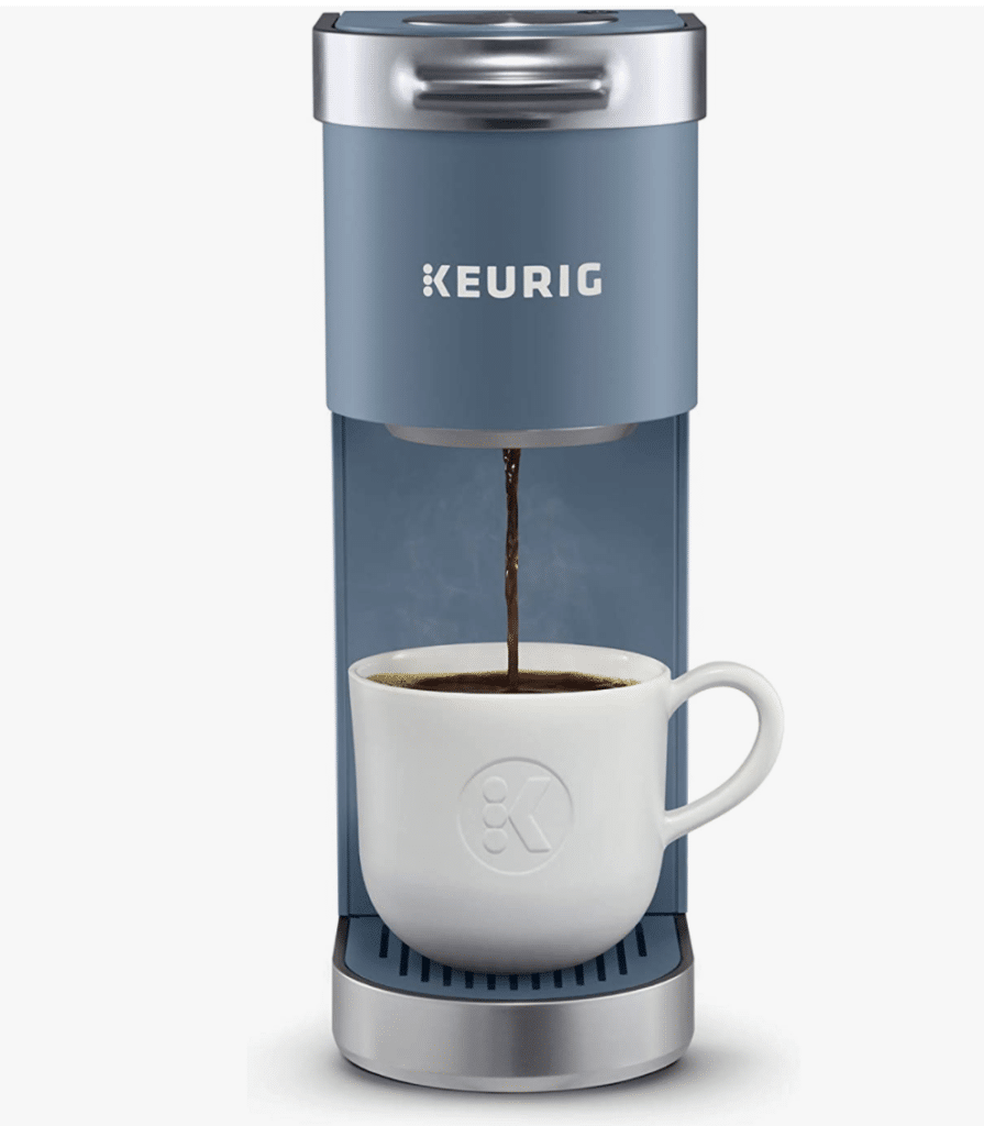 a single serve coffee pot with a coffee cup