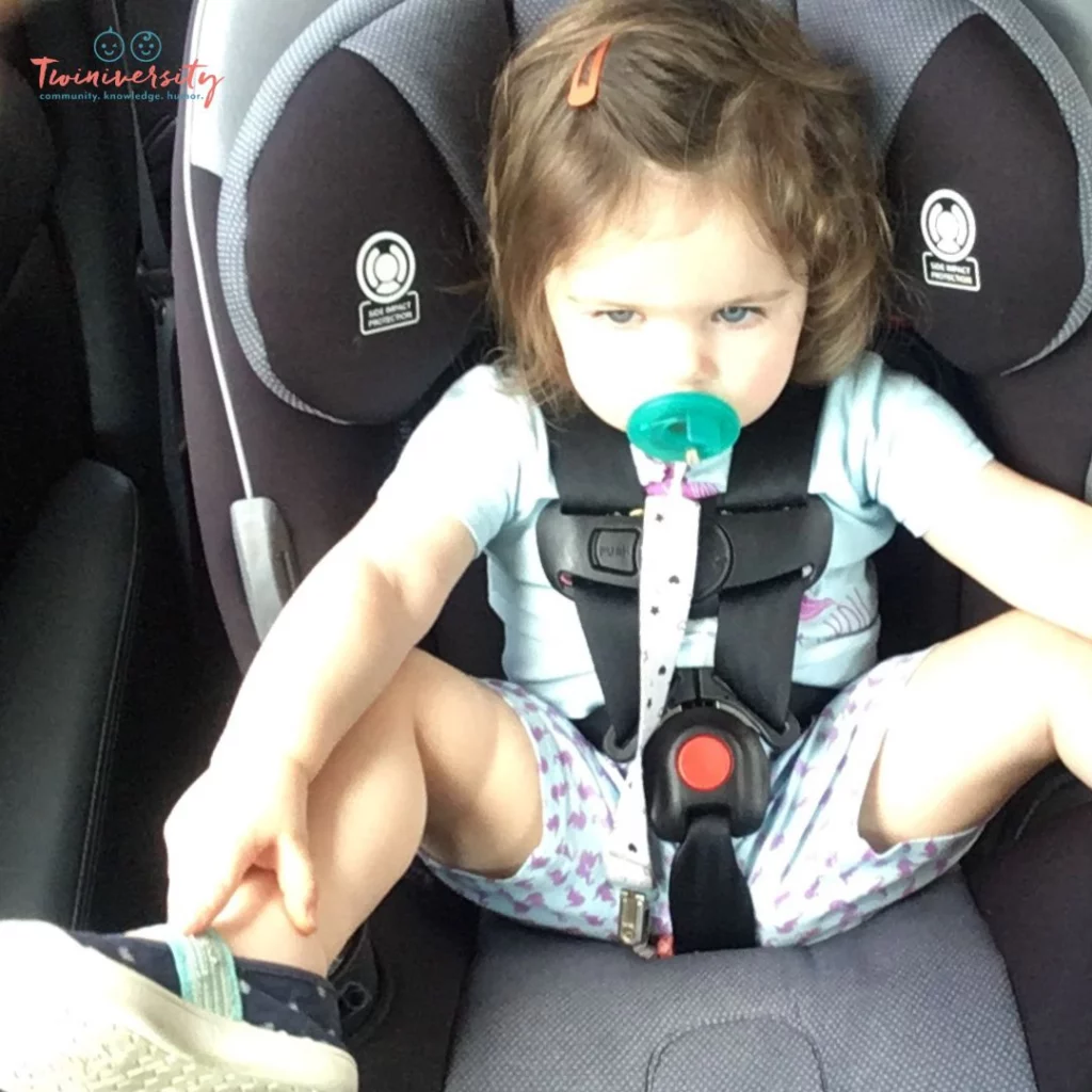 Toddler strapped in to the car seat comfortably and safe
