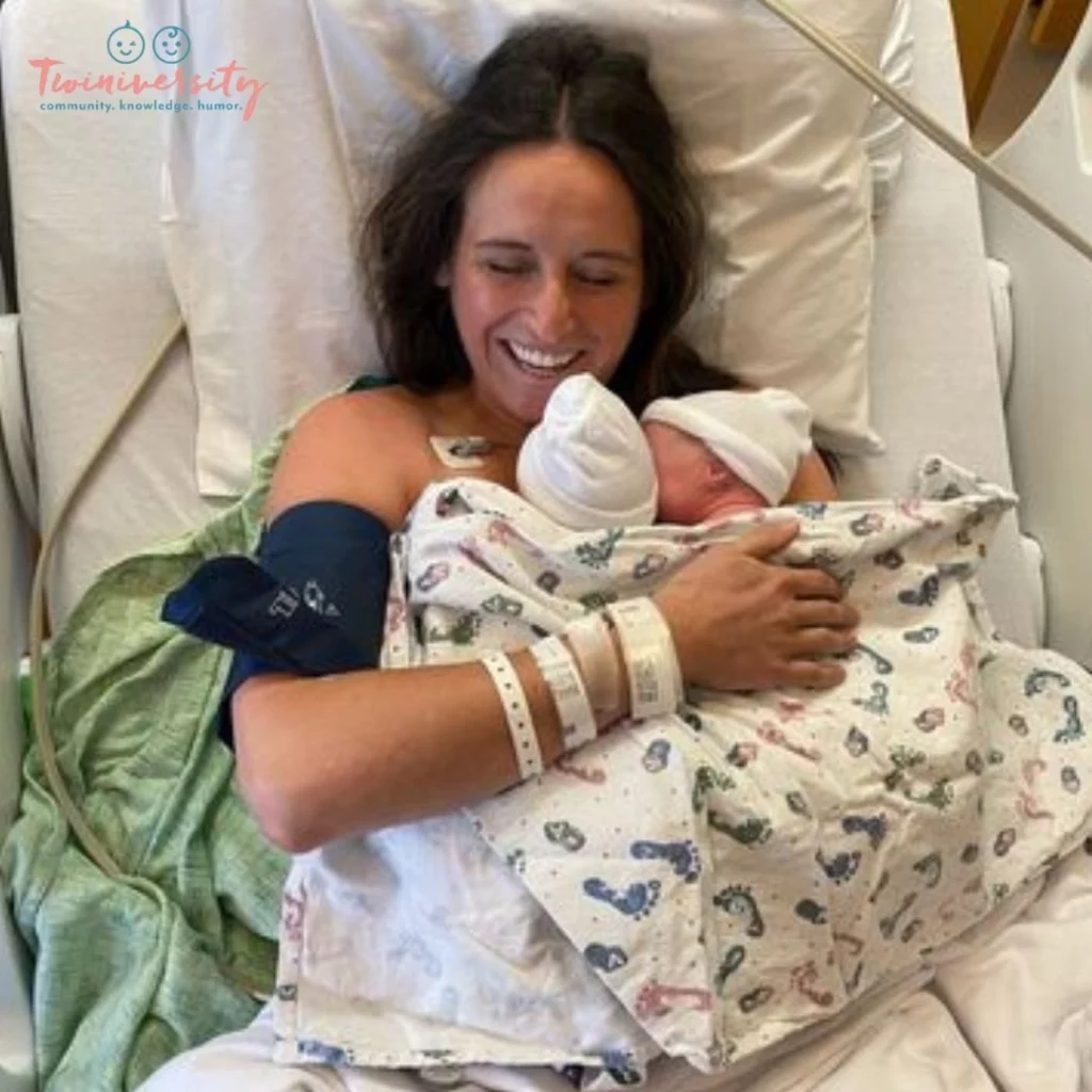 Smiling mama, holding both her twins after delivery.