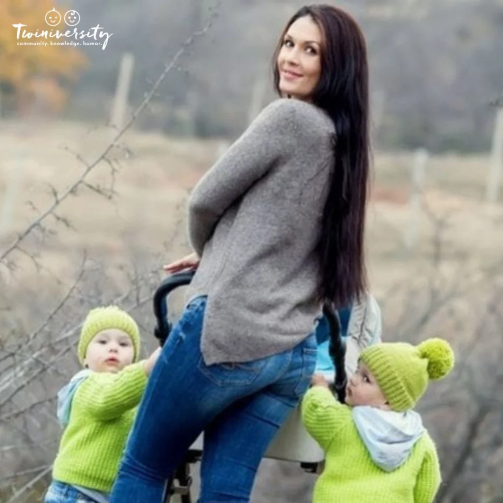 Mom holding the hands of her twins