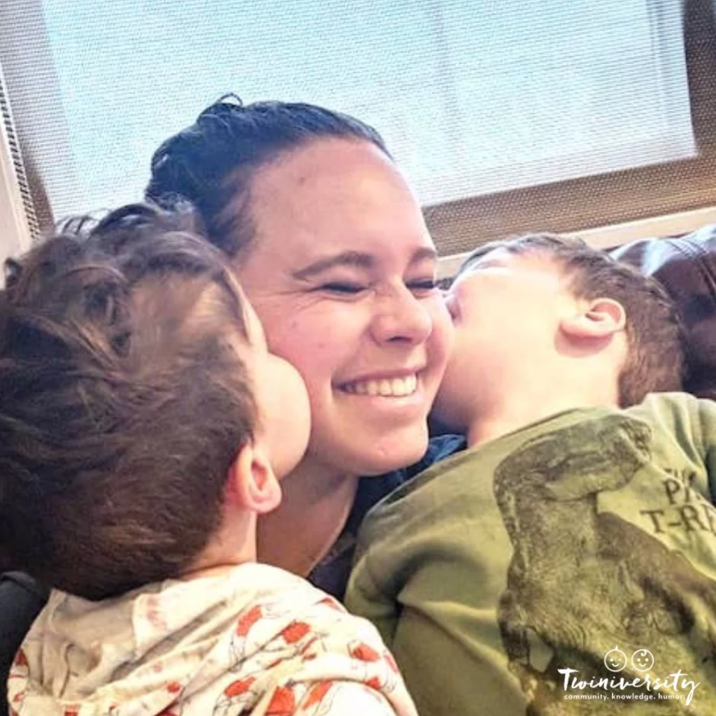 mom getting kisses on both cheeks from her twins