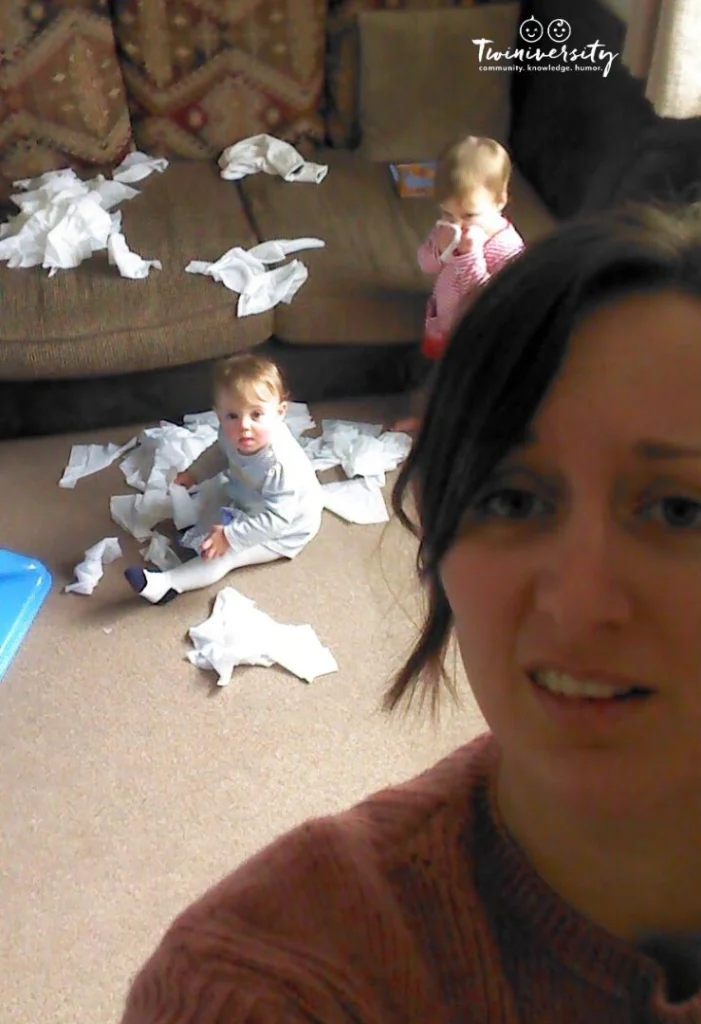 Twin mom selfie with twins and a mess in the background