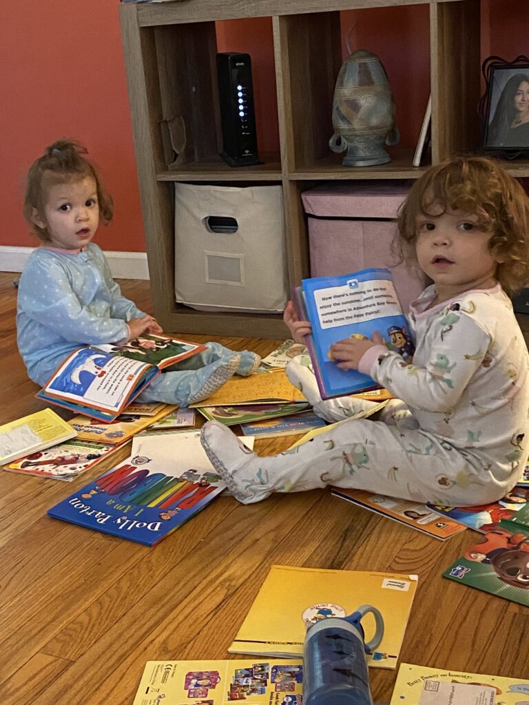 twin girls reading together for twin bonding