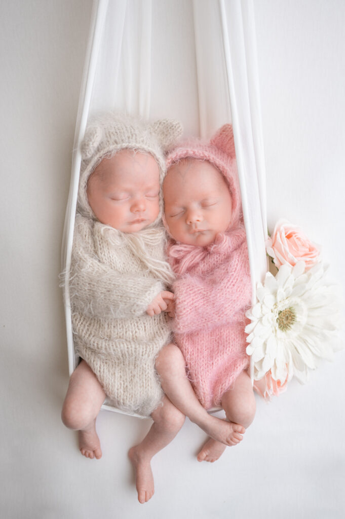 newborn twins in outfit from baby registry