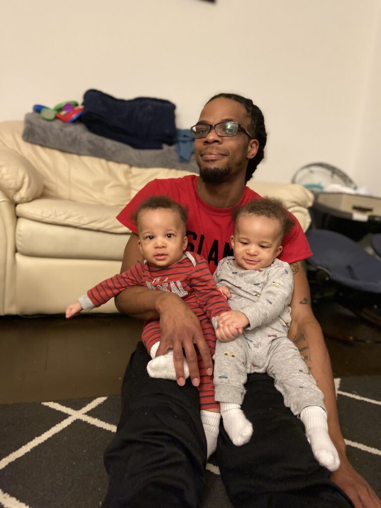 twin dad holding his twins