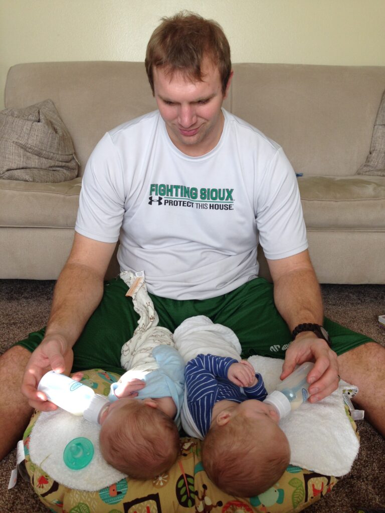 twin parent bottle feeding babies