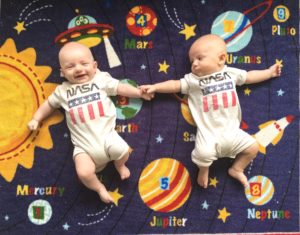 infant twins lying on a blanket stay-at-home parents of twins